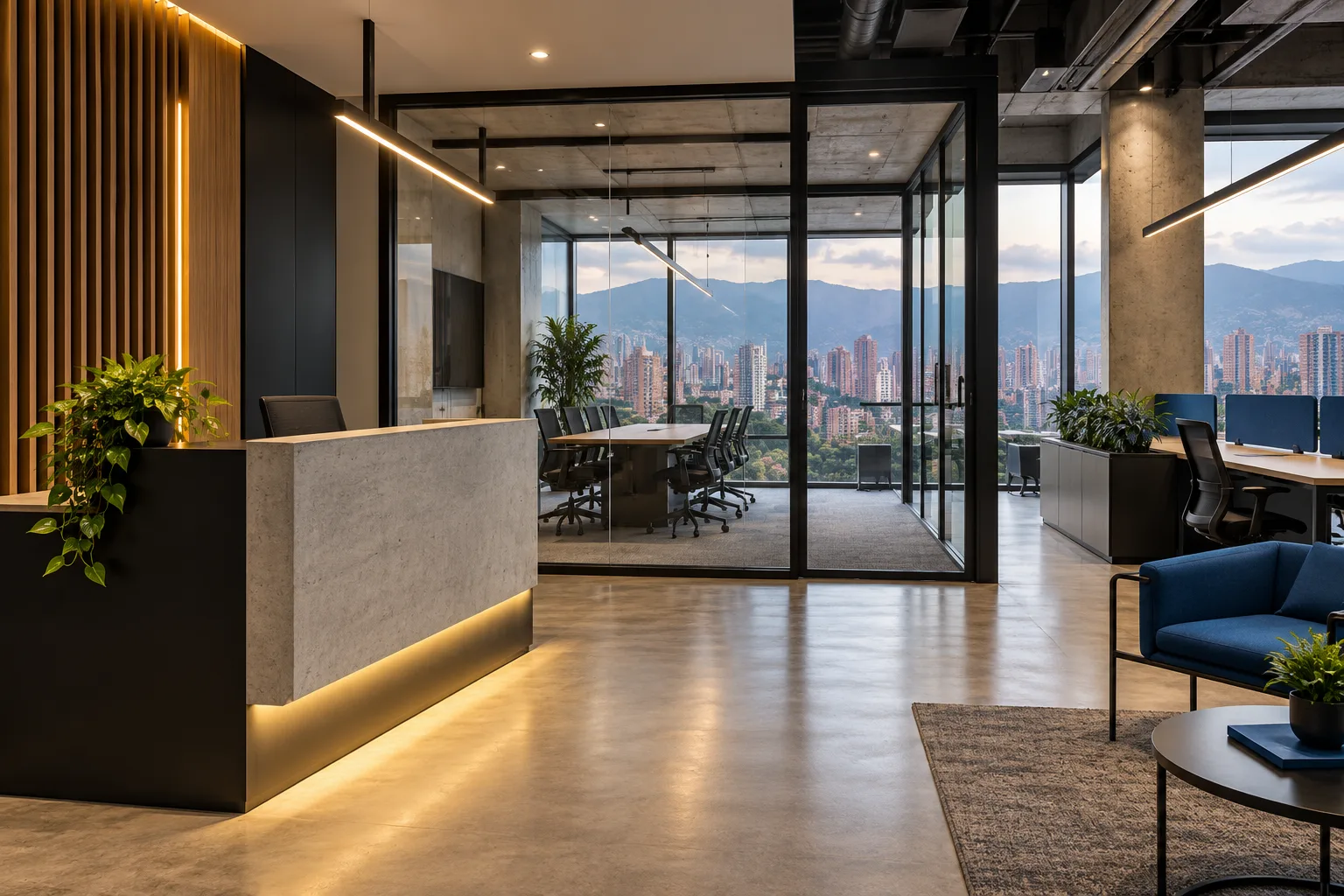 Oficina urbana en Medellín con recepción de concreto, divisiones de vidrio y vista a las montañas